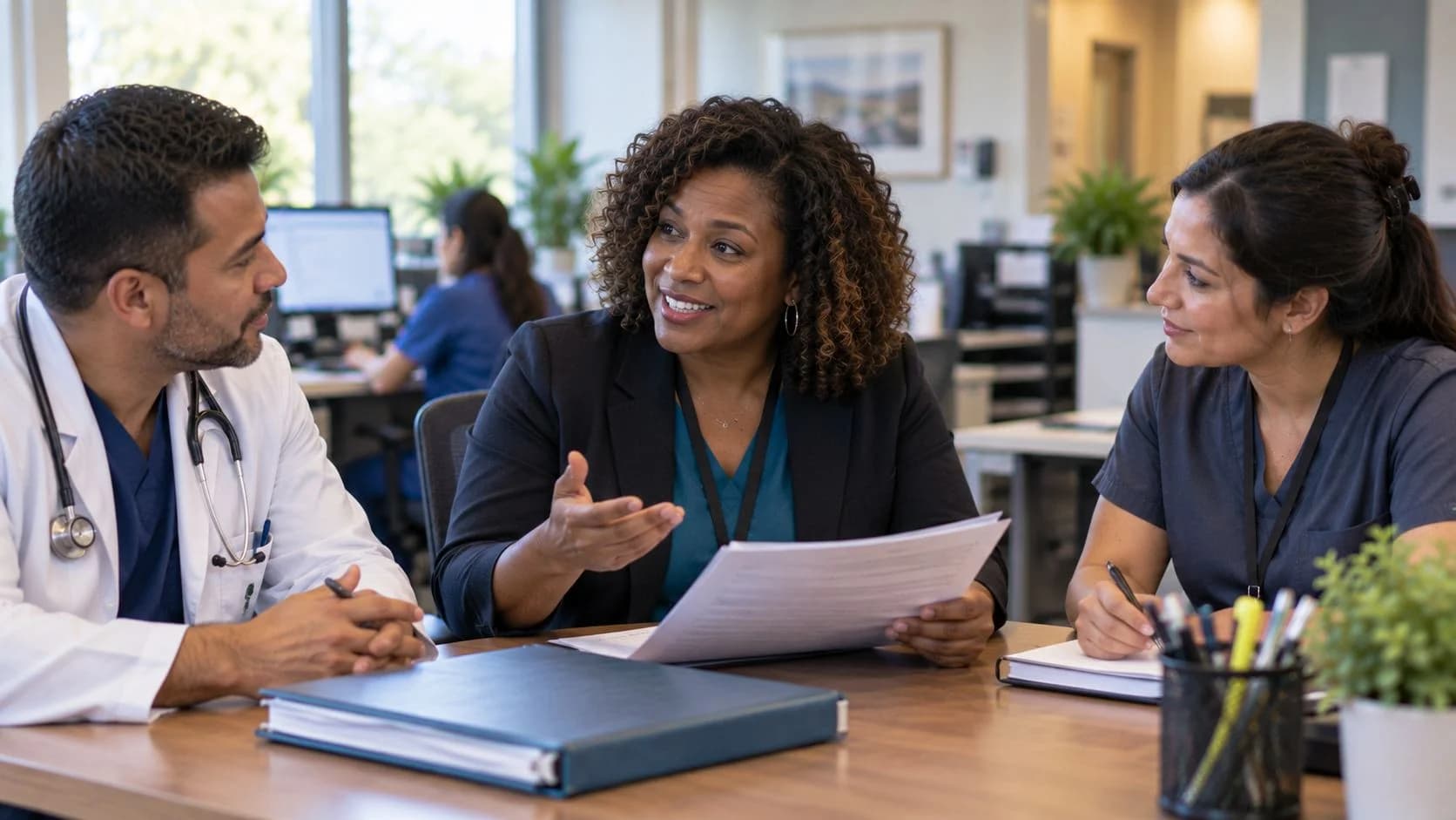 Revenue-cycle educator discussing a workflow with medical-office colleagues