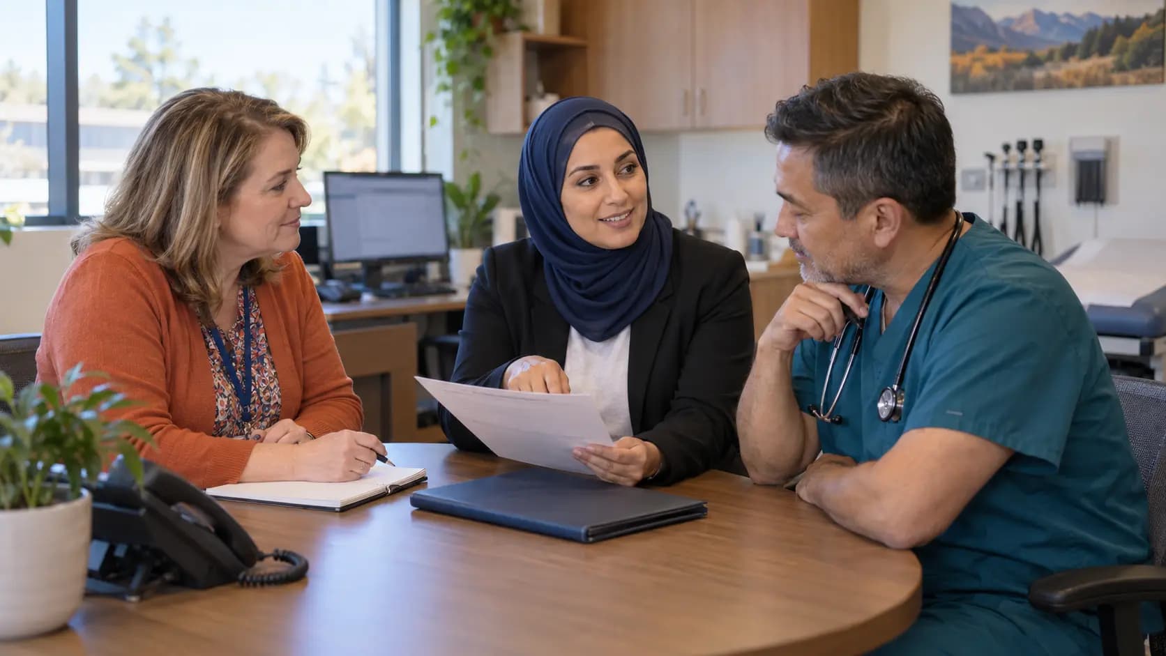 Practice manager and clinician reviewing payer requirements with a specialist