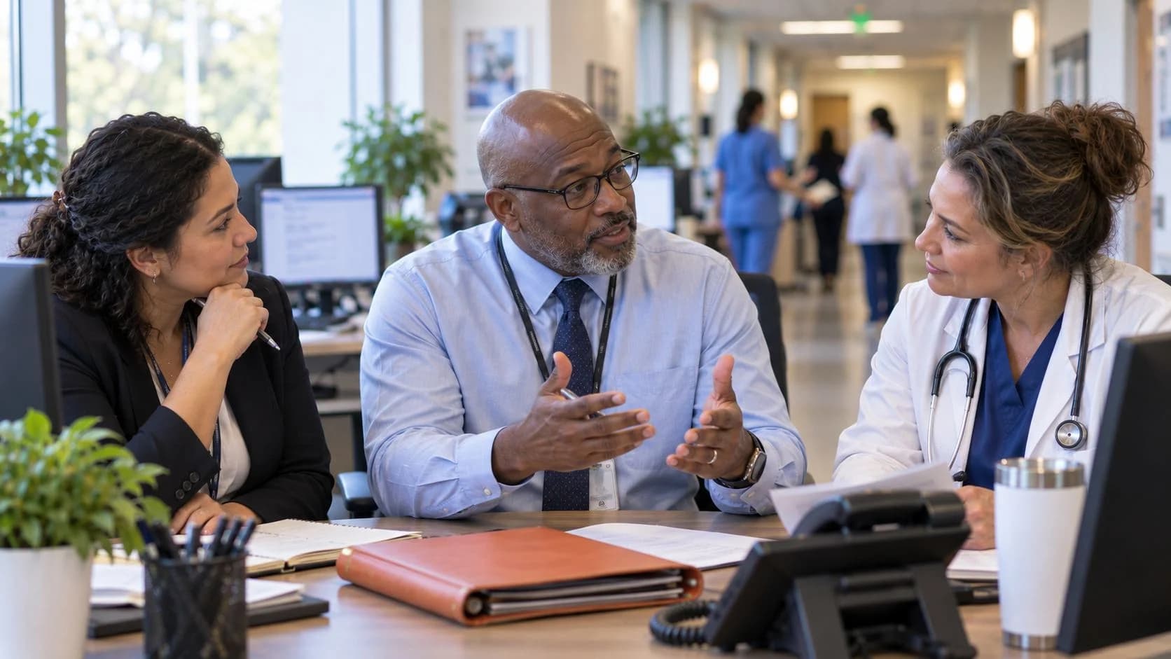 Denial-resolution specialist and clinician reviewing a claim together
