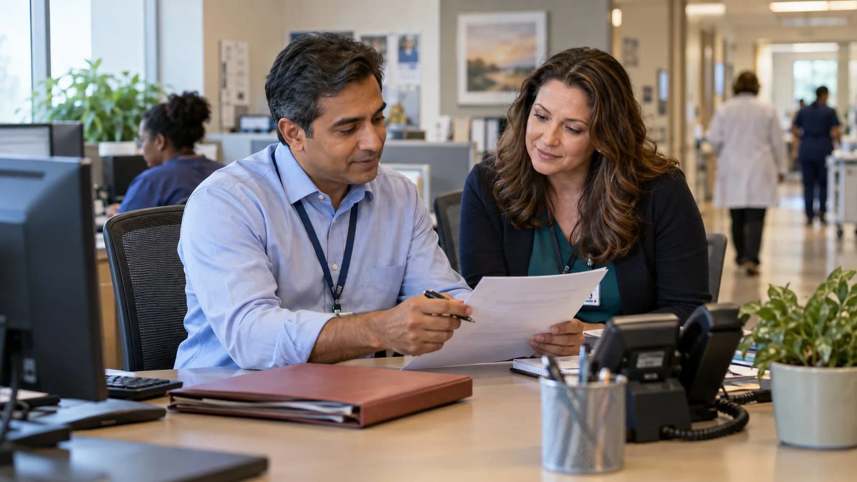 Reimbursement analyst and revenue manager reviewing a payment variance