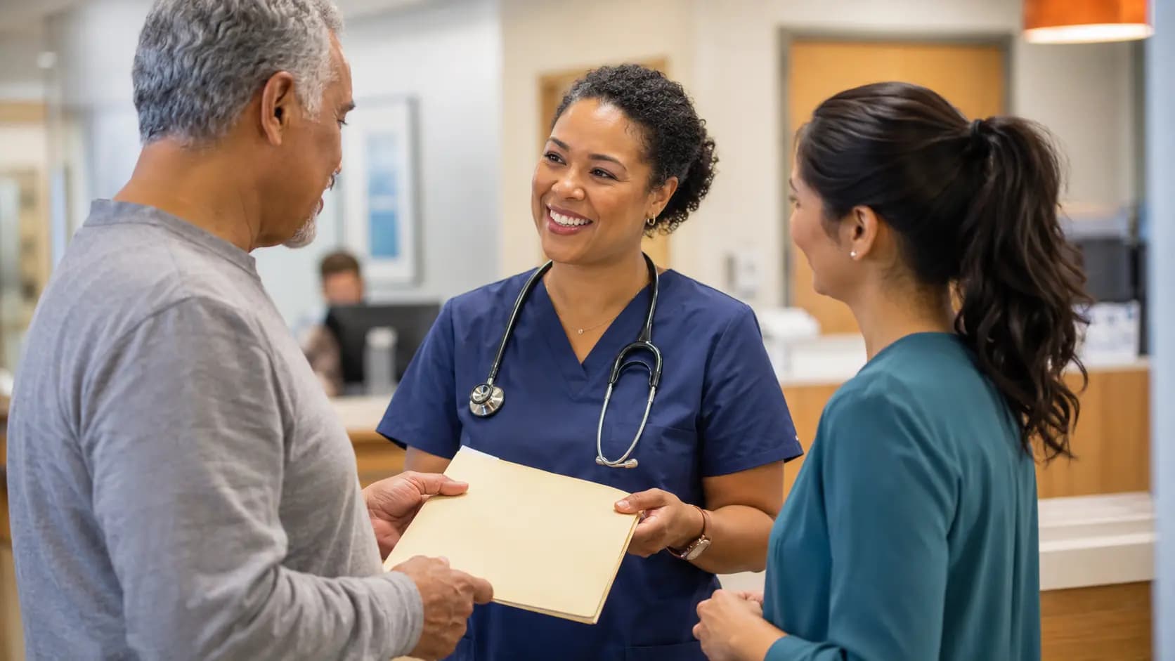 Clinician, patient, and healthcare colleague sharing a warm clinic interaction
