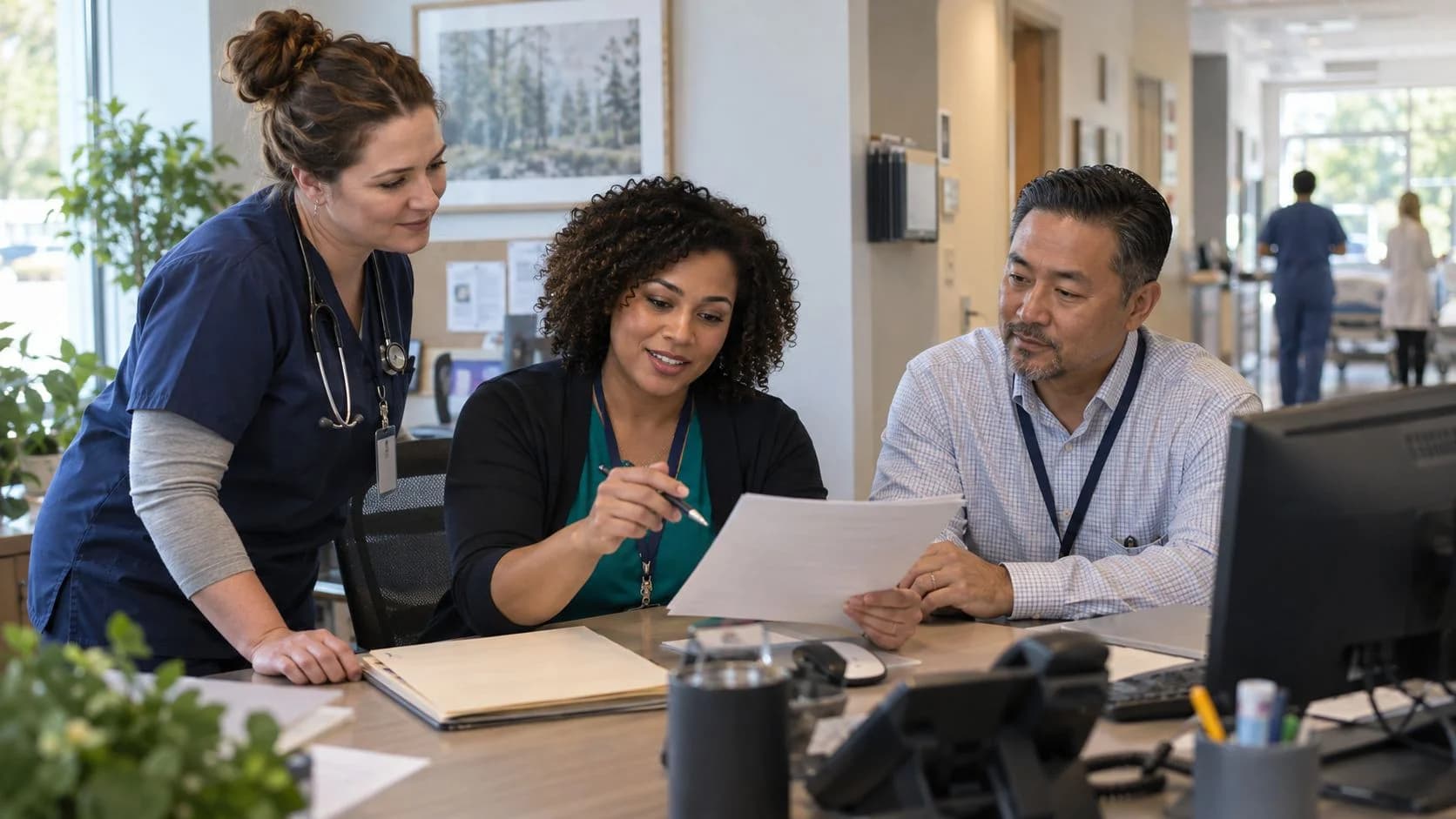Denial-resolution specialist and clinician reviewing a claim together