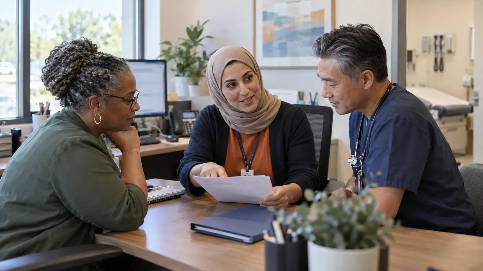 Practice manager and clinician reviewing payer requirements with a specialist