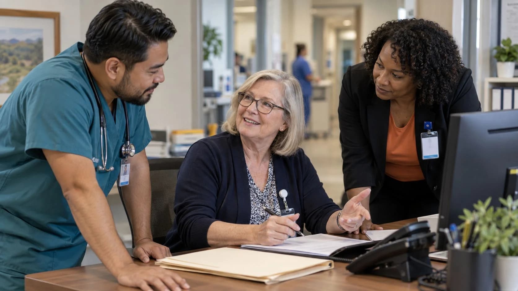 Denial-resolution specialist and clinician reviewing a claim together